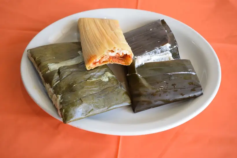 Tamales wrapped in banana leaf and corn husk